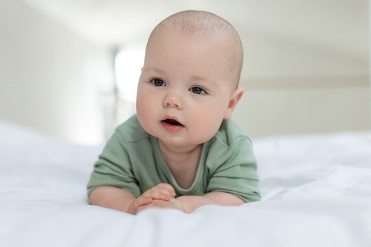 The baby lies on the bed. Little baby. High quality photo