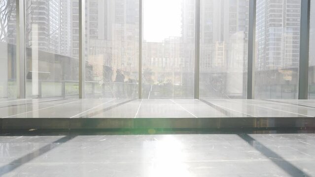 empty corridor with marble floor and glass wall
