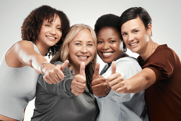 Nothing but good vibes here. Shot of a diverse group of women standing together in the studio and showing a thumbs up.