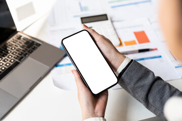 Cropped shot view of woman hands holding smart phone with blank copy space screen for your text message or information content.