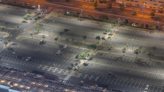 Big parking lot near mall crowded by many cars timelapse aerial view