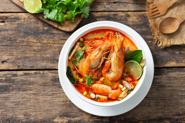 Tom Yam Kung ,Prawn and lemon soup with mushrooms, thai food in wooden bowl top view