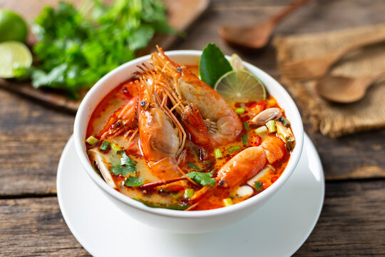 Tom Yam Kung ,Prawn and lemon soup with mushrooms, thai food in wooden bowl top view