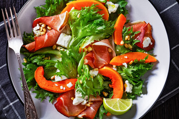 pumpkin salad with lettuce, crumbled cheese, ham
