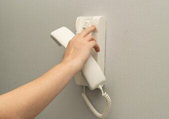 Hands opening door through intercom