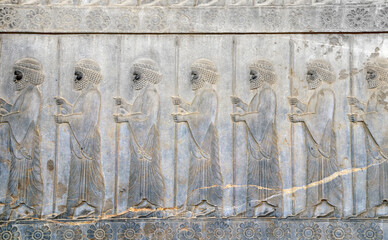 Ancient wall with bas-relief with assyrian warriors with with spears, Persepolis, Iran
