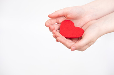 Fototapeta premium Red heart in hands, isolated on the white background
