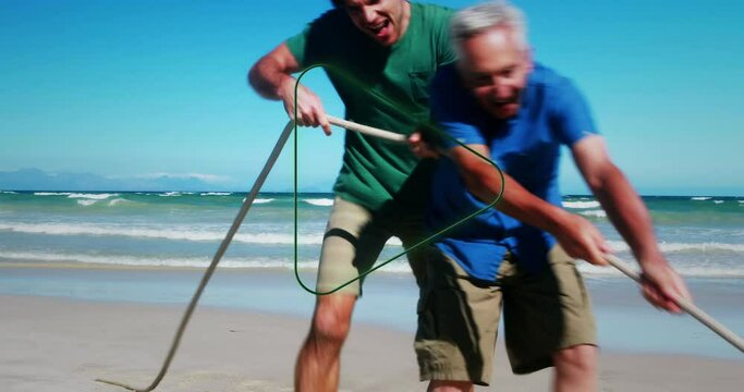 Animation Of Play Over Happy Multigeneration Caucasian Family Having Fun On Beach