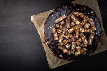 Chocolate cake with milk mousse on black background.