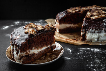 Chocolate cake with milk mousse on black background.
