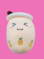 Pearl milk tea shaped pillow smiling happily and cutely on isolated pink background.