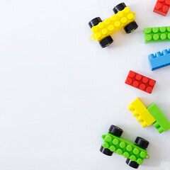 childhood and creativity concept - colorful toy constructor blocks over white background