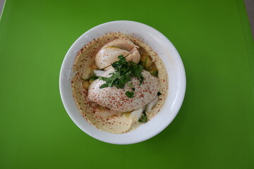Hummus served with egg, spice and olive oil