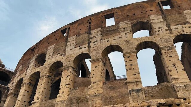 Panning shot of beautiful Amphitheater Architecture in Rome during cloudy day - Colosseum Building In Rome Capital of Italy