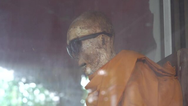 Mummified Monk Wearing Dark Glasses At Wat Khunaram Temple In Koh Samui, Thailand. Close Up, Side View