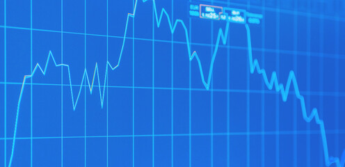 Daily trading prices on the online stock market graph showing on blue screen.Daily investor's business everyday life.Banner,selective focus.
