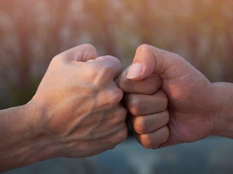 Close up of deal of teamwork  with the Man hand a fist bump commit as get together in the office