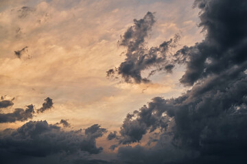 Dramatic colorful twilight sky before a thunderstorm with wind clouds on a black sea beach