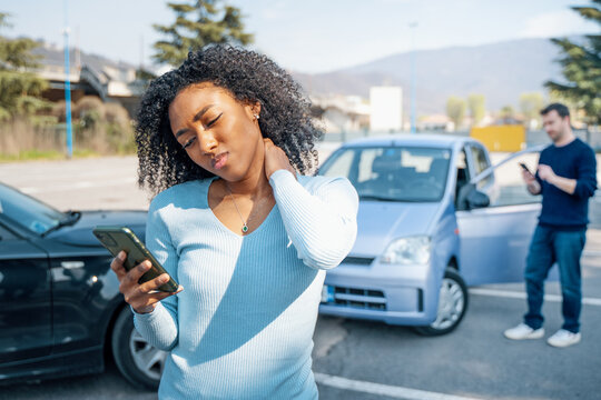 Black woman calling insurance support after car crash
