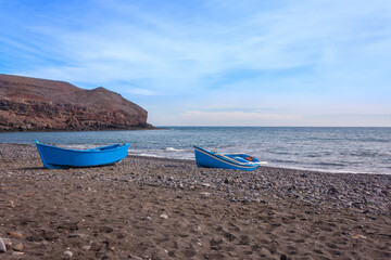 Fototapeta na wymiar Blue rowing boats at Fuerteventura coast
