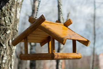 A bird house. A wooden birdhouse on a tree.