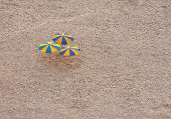 Three parasols at the beach, high angle view