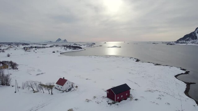 Revealing Norwegian traditional Farm nice winter scenery landscape, backward aerial drone shot.