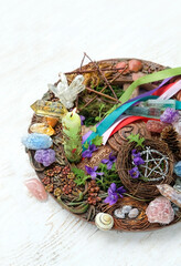 Wiccan altar for Beltane sabbath. spring pagan festive ritual. wheel of the year, colorful ribbons,...