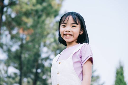 Portrait of Asian little girl playing in the park