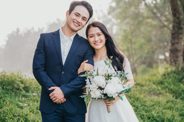 Image of young Asian bride and groom - Powered by Adobe
