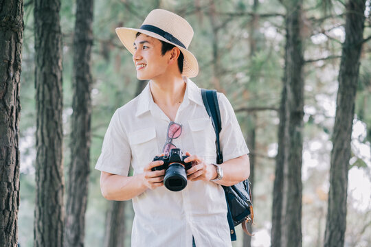 Portrait of young Asian man traveling