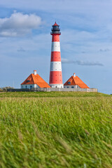 Fototapeta na wymiar Westerheversand Lighthouse on Eiderstedt peninsula, Germany