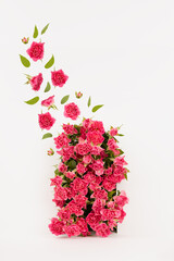 Elegant arch of fresh little roses as abstract podium with flying buds and green leaves as swirl on white stage for presentation cosmetic products, mockup, vertical. Template for advertising, design.