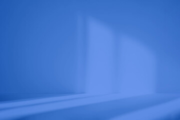 Abstract blue studio background for product presentation. Empty room with shadows of window. Display product with blurred backdrop.