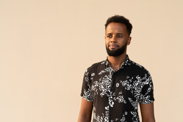 Obraz premium Portrait of handsome young African man against plain background