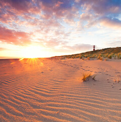 romantic landscape in the dunes with lighthouse