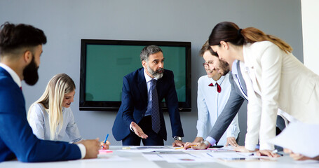 Collaboration and analysis by business people working in office