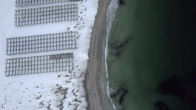 Wooden dry fish racks at hovden Beach Norway Bo in Vesteralen, Bird view shot 4k