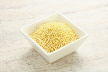 Raw couscous in the bowl