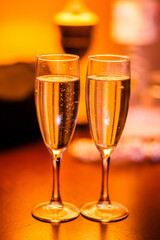 Two glasses of cold champagne. Warm shades.