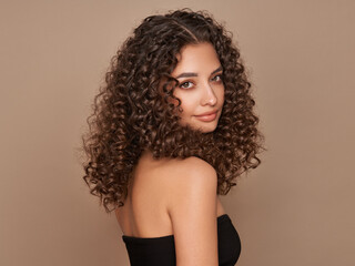 Fashion studio portrait of beautiful smiling woman with afro curls hairstyle. Fashion and beauty - 498469673