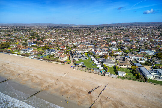East Preston village Seafront and beach in West Sussex on the south coast of England with the South Downs in the background, Aerial view.
