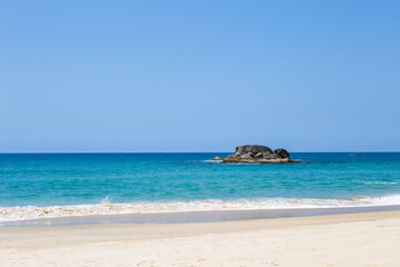 Clean sandy beach with beautiful blue sea and clear sky, tropical beach in south of Thailand, nature background