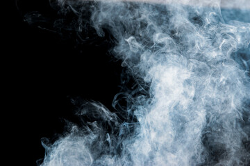 Fototapeta na wymiar gray smoke with a blue tint on a black background