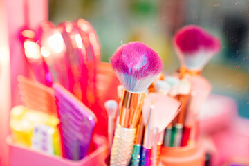 pink makeup brush. dressing table with decorative cosmetics