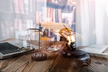 Business and lawyers discussing contract papers with brass scale on desk in office. Law, legal services, advice, justice and law concept picture with film grain effect