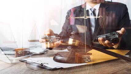 Business and lawyers discussing contract papers with brass scale on desk in office. Law, legal services, advice, justice and law concept picture with film grain effect