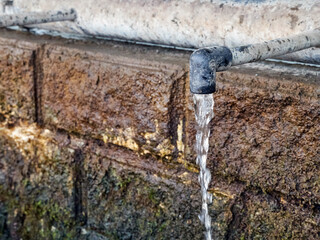 Clean drinking water flows continuously from the tap of a natural source. Lack of clean drinking water. Drought.