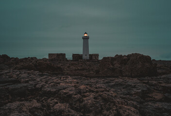 lighthouse in the cliff at dusk