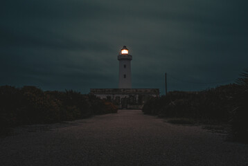 lighthouse in the cliff at dusk